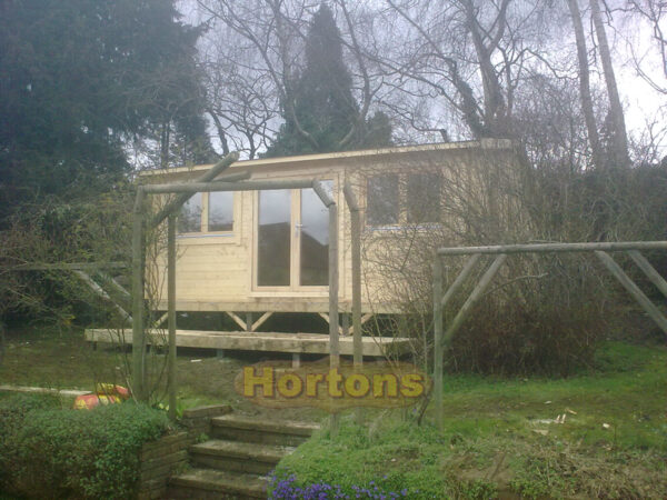 6x3m garden room in garden with decked area