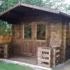 3m x 5m garden cabin with veranda and factory stained installed