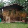 3m x 5m log cabin front and glazed side wall in garden