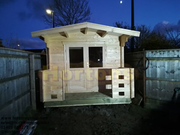 3m x 7m garden cabin front wall installed in thin garden