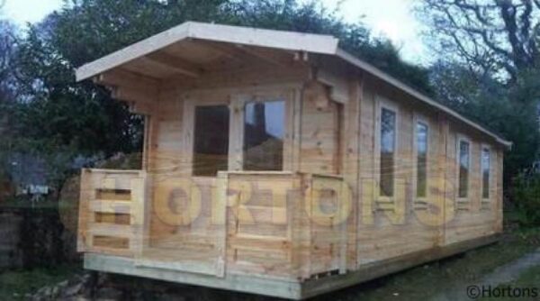 3m x 8m log cabin with veranda on timber base